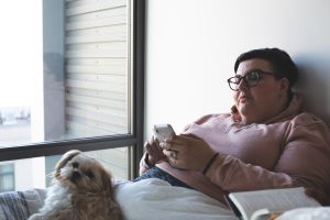 Woman in bed on phone